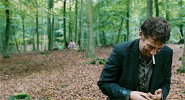 A gif of Clive Owen falling against a tree in grief from the film Children of Men